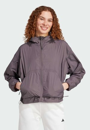 Leichter, kapuzenförmiger, lila Windbreaker mit Reißverschluss, elastischen Bündchen und Vorderaschen. Glatte Textur mit lockerer Passform.
