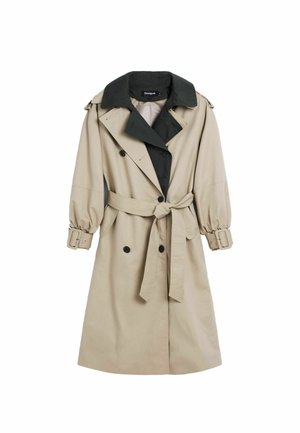 Manteau beige avec un col noir, design croisé, taille à nouer et manches bouffantes. Présente de grands boutons noirs et une boucle de ceinture.
