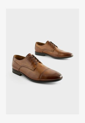 Rudos odinės klasikinės bateliai su smailiu nosiu, rišamos konstrukcijos ir subtiliais siuvinėjimo akcentais. Lygus paviršius ir žemas kulnas.