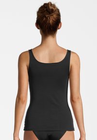 Black tank top with narrow straps, fitted design, and smooth texture, viewed from the back. No patterns or hardware details visible.