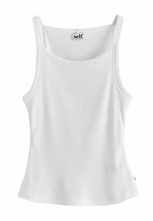 Débardeur blanc côtelé sans manches avec un col rond et une petite étiquette portant l’inscription « self. » au niveau du col.