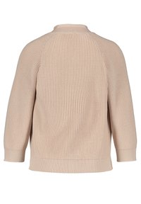 Bežový pletený svetr s žebrovanou texturou, raglánovými rukávy a kulatým výstřihem. Má volný střih a rovný lem v pase.