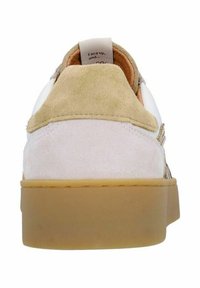 Suede and leather sneaker in beige and tan with a rubber sole. Features a padded heel tab and branding on the tongue.