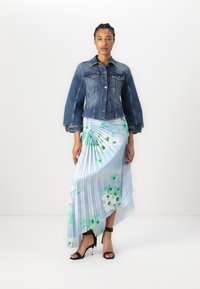 Denim jacket with a fitted waist and long sleeves, paired with a pleated, light blue skirt featuring floral patterns in green and white.