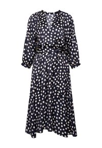 Robe midi bleu marine à pois blancs, manches longues, col en V, ceinture nouée à la taille, en tissu fluide.
