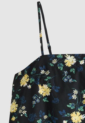 Zwarte spaghetti-strap top met gele, witte en blauwe bloemenprint en groene bladeren, getoond vanaf de bovenkant voorkant met verstelbare bandjes.