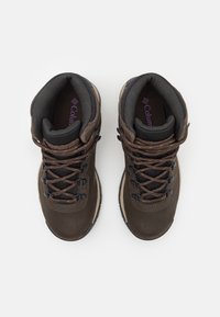 Brown hiking boots featuring a leather and mesh upper, black hardware, lace-up design, and padded collar for comfort.