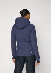 Navy blue hooded jacket with a smooth texture and fitted design, featuring a logo on the lower back and dark cuffs.
