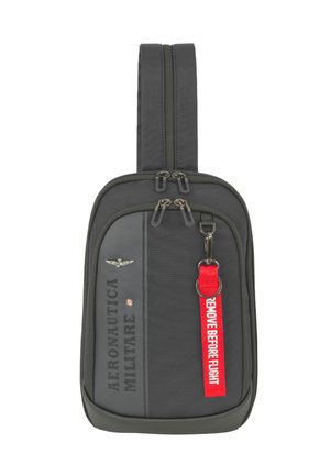 Piccolo zaino a tracolla grigio scuro con cerniera verticale, scritta "AERONAUTICA MILITARE" e portachiavi rosso con la scritta "REMOVE BEFORE FLIGHT".