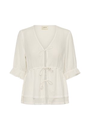Lagano bluzica boje kreme s tromočnim pjufastim rukavima, V-izrezom i tri vezice sprijeda.