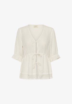 Lagano bluzica boje kreme s tromočnim pjufastim rukavima, V-izrezom i tri vezice sprijeda.