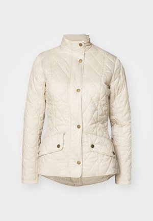Veste matelassée de couleur crème avec col haut, boutons-pression à l'avant et deux poches avant à rabat avec fermeture pression.