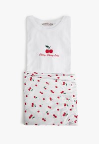 Vitt bomullset med ribbad textur; toppen har röd körsbärsbroderi och texten "Cherry, Cherry Lady"; botten har vit bakgrund med körsbärsmönster.
