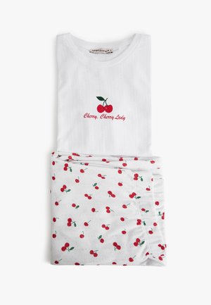 White cotton set with ribbed texture; top features red cherry embroidery and text "Cherry, Cherry Lady"; bottom has white background with cherry pattern.