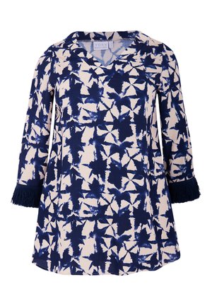 Tunique en motif marine et crème avec un décolleté en V, des manches trois-quarts et des accents à frange aux poignets. Fabriquée à partir d'un tissu doux et texturé.