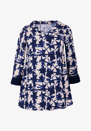 Gestreifte Tunika in Marineblau und Creme mit V-Ausschnitt, dreiviertel Ärmeln und Fransenakzenten an den Manschetten. Hergestellt aus weichem, strukturiertem Stoff.