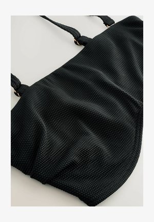 Svart bikiniöverdel i textur med våffelmönster, försedd med justerbara flätade axelremmar och detaljer i guldton.