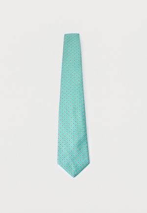 Corbata turquesa con pequeño patrón floral de lunares blancos y rojos sobre un fondo liso claro.
