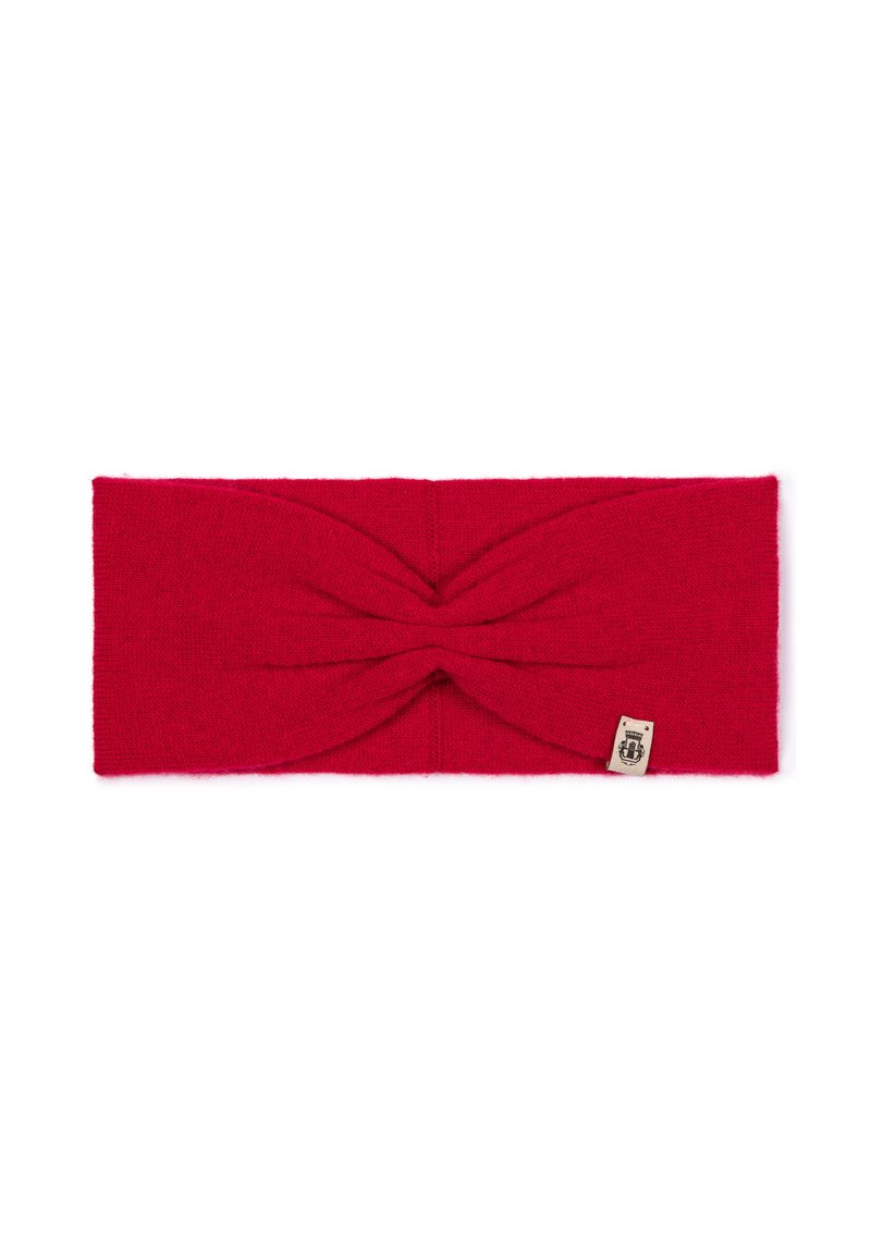 Red knitted headband with a twist design at the front. Soft texture, elastic material, and a small label attached on the side.