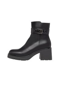 Black leather ankle boot with a textured surface, block heel, and a wide strap featuring a metallic buckle detail. Stitched accents on sides.