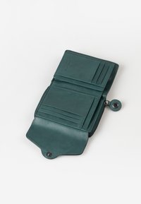 Green leather wallet with a zip closure, multiple card slots, and a snap button detail. Smooth texture with a rectangular shape.
