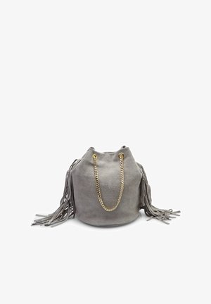 Gray suede bucket bag with fringes, gold chain handles, and a drawstring closure. Soft texture with a rounded base and tapered top.