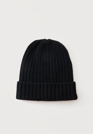 Bonnet en maille côtelée noir avec revers plié, posé à plat sur un fond blanc.