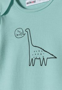 Mint zelena pamučna bodi s crnim obrubom dinosaura i natpisom "Ja sam glasan!" u balonu za govor. Mekana, rebrasta tekstura.