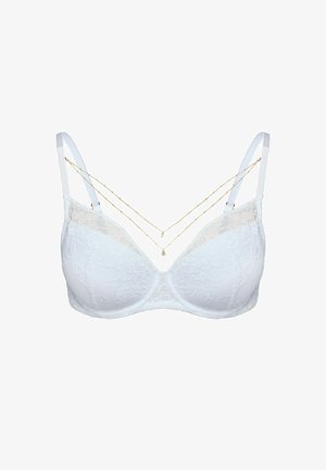 White lace bra with padded cups, adjustable straps, and a lace overlay. Features two delicate gold chains draped across the front.