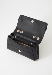 Borsa in pelle nera con finitura texturizzata. Presenta un compartimento con cerniera e dettagli in metallo dorato. Chiusura con molla magnetica.