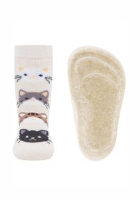 Skarpety w wzory przedstawiające cztery kocie twarze w odcieniach beżu, brązu i czerni na jasnobeżowym tle. Dno ma teksturowaną powierzchnię dla lepszej przyczepności.