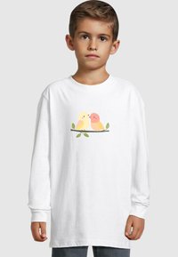 White long-sleeve t-shirt features a graphic of two colorful cartoon birds on a branch with green leaves. Soft cotton fabric, relaxed fit.