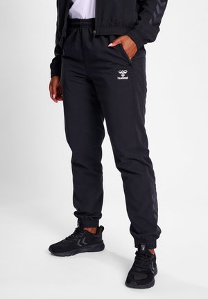 TRAVEL  - Tracksuit bottoms - black