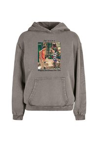 Grå hoodie med ficka fram. Har en tryckt bild från "Friends" ovanför texten "Glad julaftonseve. " Mjuk tygkänsla.