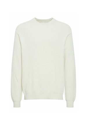 Lys kremfarget ribbestrikket genser med rund hals, lange ermer og tettsittende mansjetter, laget av et mykt stoff med strukturert overflate.