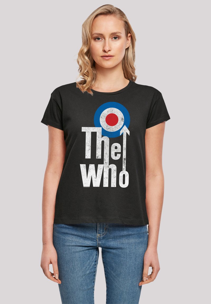 Black t-shirt featuring bold white text "The Who," with a blue and red circular graphic above. Short sleeves and a relaxed fit.