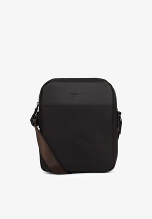 Compact zwart crossbodytas met rechthoekige vorm, voorvak en verstelbare donkerbruine schouderriem.
