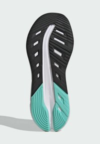 Suela de zapatilla atlética negra y turquesa con un patrón texturizado, ranuras para tracción y un acento en la mediasuela blanca.