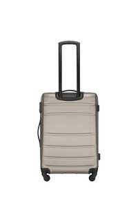 Cabin-sized suitcase in a light grey hard shell with horizontal grooves, extending black handle, and four wheels for mobility.