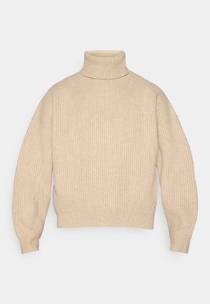 Maglione a collo alto a coste beige con maniche lunghe e una vestibilità leggermente cropped e rilassata.