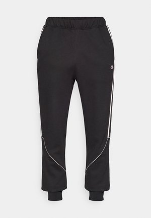Black sweatpants with a relaxed fit, elastic waistband, white side piping, and ribbed cuffs. Made from a soft, stretchy fabric.