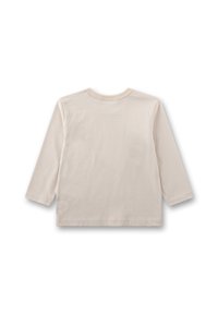 Langärmliges, cremfarbenes Hemd aus weicher Baumwolle, mit Rundhalsausschnitt und einfacher Naht entlang der Kanten.