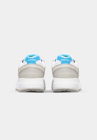 White running shoes with a gray suede midsection and blue accents. Features a padded collar, textured fabric, and rubber sole for traction.