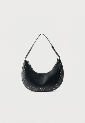 Black leather crescent shoulder bag with silver studs along edges and an adjustable strap on a white background.