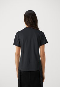 Calvin Klein MULTI LOGO REGULAR T-SHIRT - T-shirts basic - black