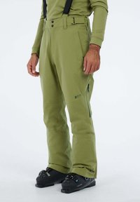 Groene skibroek gemaakt van duurzaam materiaal, met verstelbare bretels, ritszakken en een recht model.