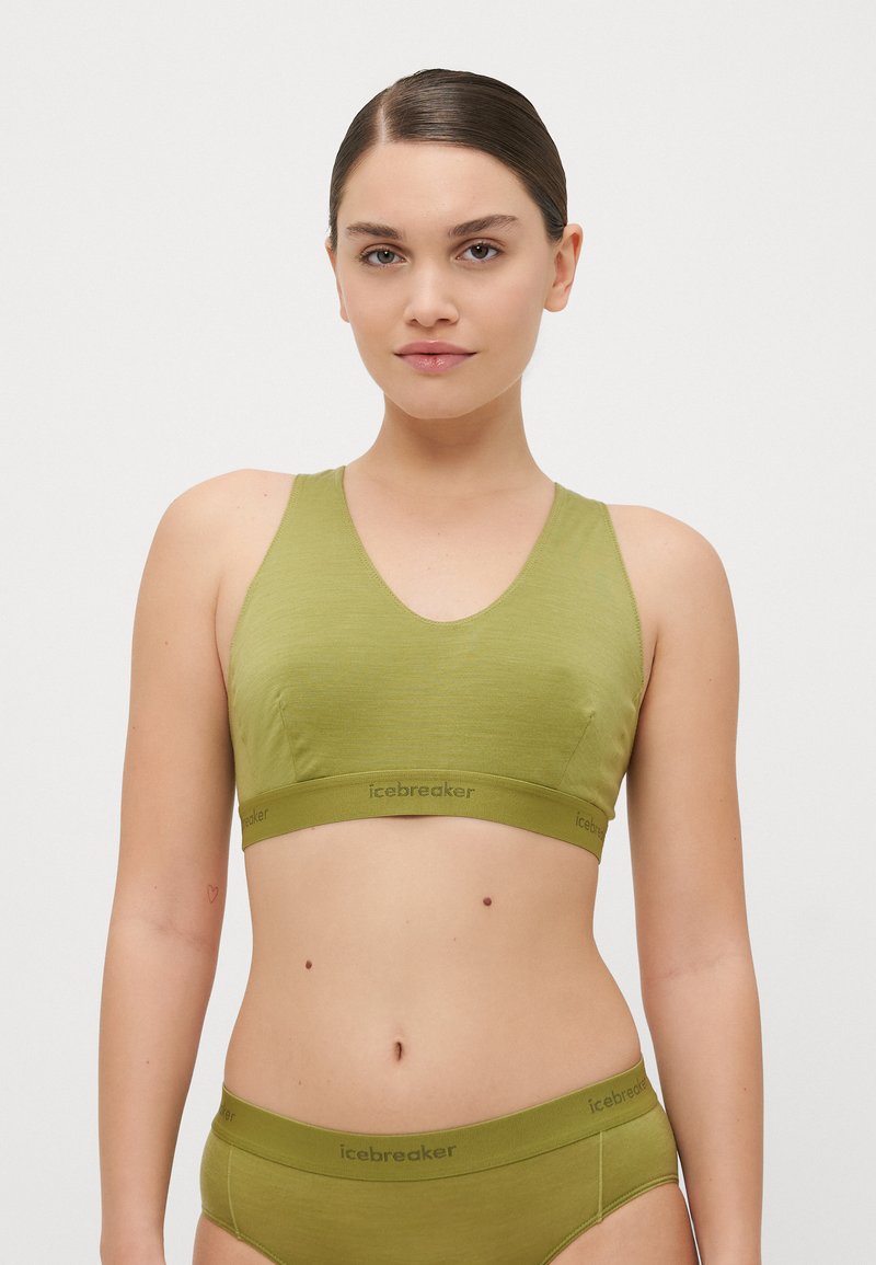 Bralette verde-azeitona com decote em V, alças largas, construção sem costuras e uma banda elástica com marca na bainha.