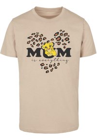 Bežinė medvilninė marškinėliai su juodu tekstu "MAMA yra viskas" ir geltonu animaciniu liūtu, apsuptu leopardų rašto širdies motyvo.