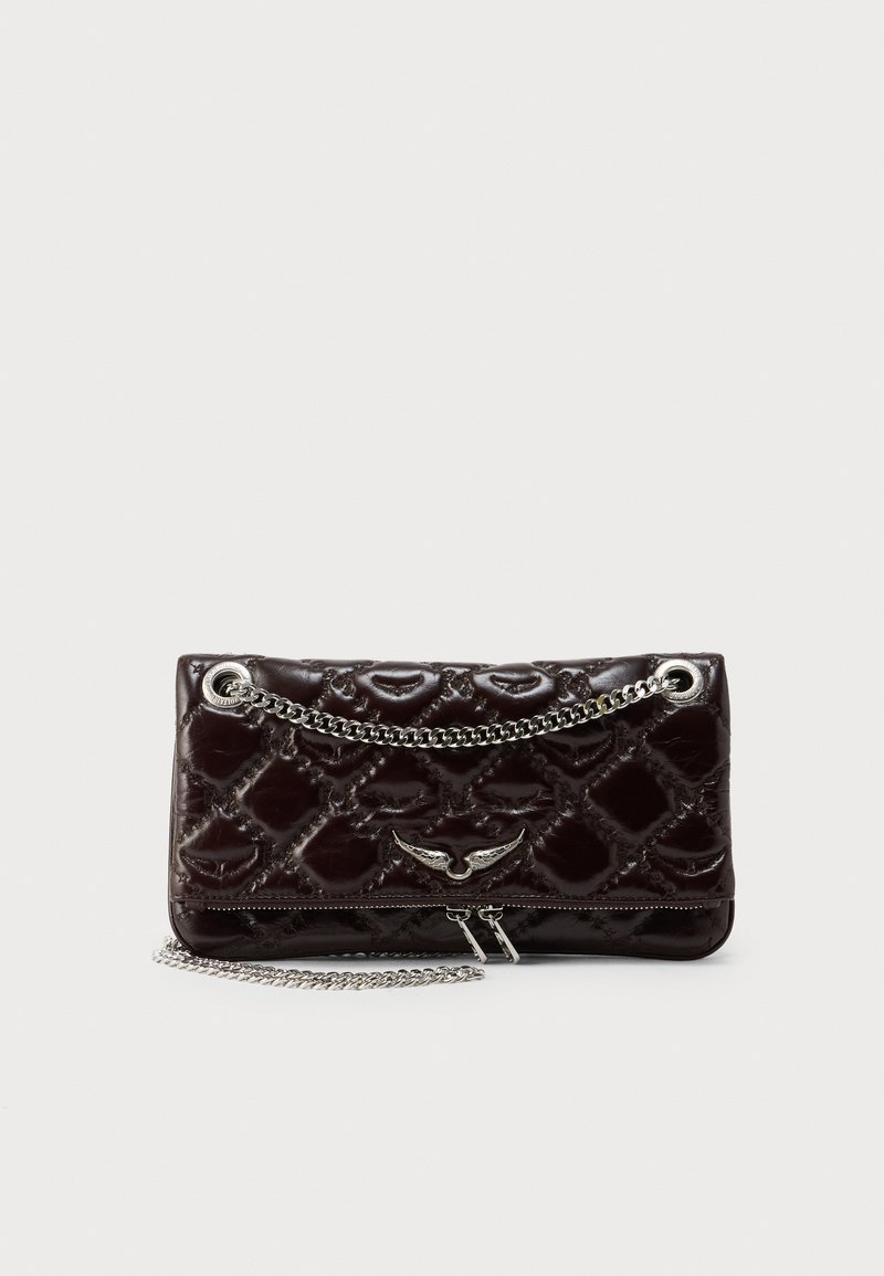 Dark brown quilted handbag in patent leather with silver chain strap and hardware. Features a zip closure and decorative wing-shaped accent.