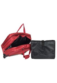 Red rolling luggage with zippered opening, spacious interior, and retractable handle, paired with a detachable black storage pouch.